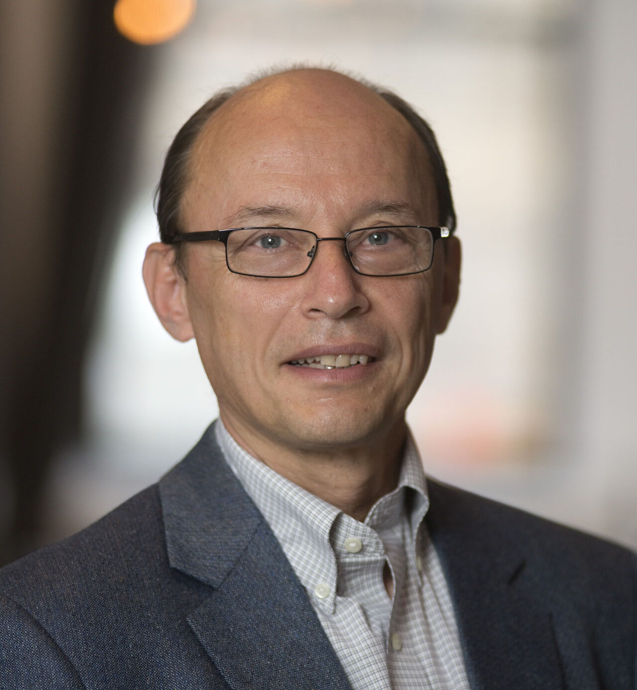 Professor Leslie Greengard wearing glasses poses for a headshot.